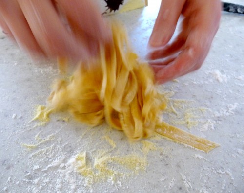 making fresh pasta - tossing noodles