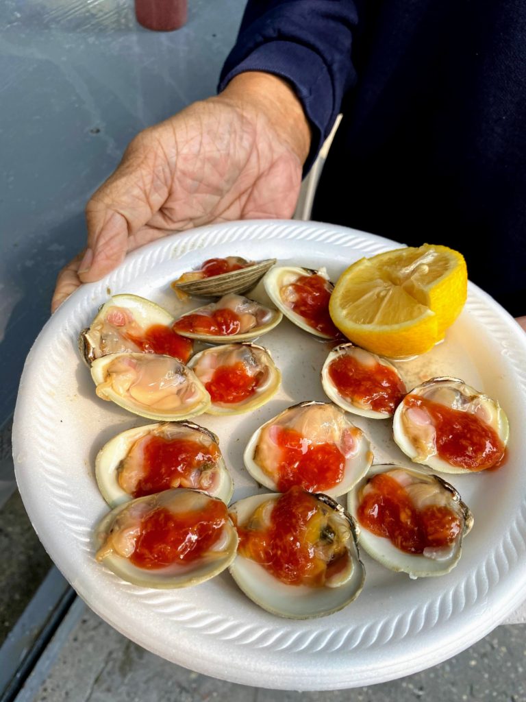 eating fresh clams on the street Arther Ave Bronx